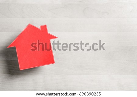 Real estate business. House for sale. Cottage made from cardboard paper on wooden table. House warming party template. Selling and buying home. Empty blank negative copy space. 