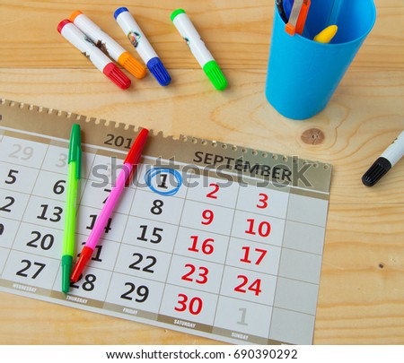 Back to school, calendar, colorful marker pens on wooden background. Royalty-Free Stock Photo #690390292