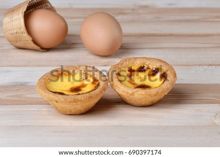Egg tart on floor wood.