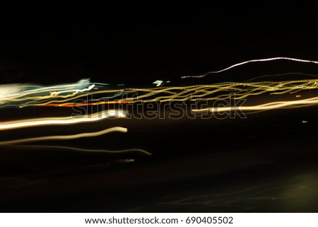 Abstract colorful light painting on dark background. Slow speed shutter