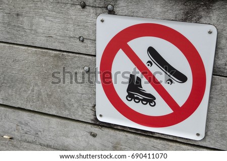 Warning sign for no skateboard and roller skate in public places.