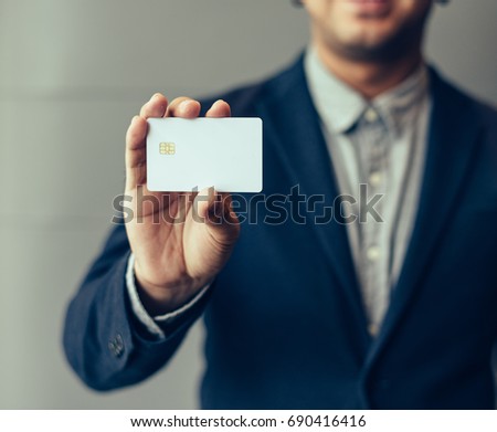 Man holding white business card,Man wearing blue shirt and showing blank white business card. Blurred background. Horizontal mockup, Smart asian business Person Professional Occupation cheerful