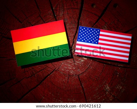 Bolivian flag with USA flag on a tree stump isolated
