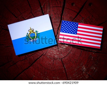 San Marino flag with USA flag on a tree stump isolated