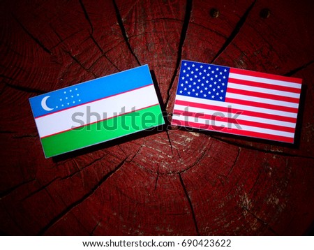 Uzbekistan flag with USA flag on a tree stump isolated