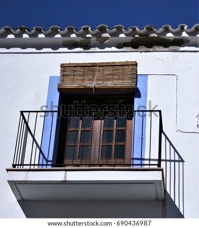 Balcony in Ibiza,House facade white an blue indigo colors in historic center of Ibiza, house of ibiza, Spain., , cobbled streets and steep,narrow streets 