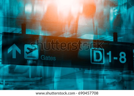 Double exposure of sign at airport with gate arrow for departing flights,