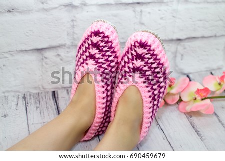 Beautiful woman legs in knitted boot slippers