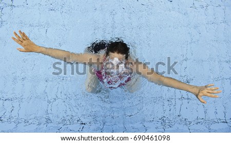 Woman swimming in spa pool, summer vacation