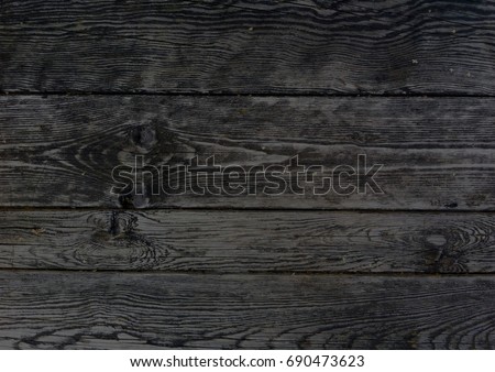 Dark wooden boards, planks. Naturally aged wood, natural brushing process. The top view. Close-up. The stock photos.  