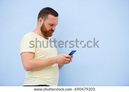 man makes faces in a funny and humorous phone shows a language, an advertising company.