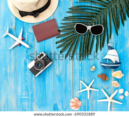 Summer Fashion woman big hat and accessories, camera and sunglasses go to travel in the beach. Tropical sea.Unusual top view, coconut background.  Summer Concept.