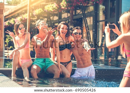 Group of friends together in the swimming pool leisure