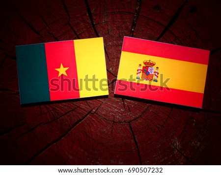 Cameroon flag with Spanish flag on a tree stump isolated