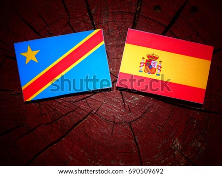Democratic Republic of the Congo flag with Spanish flag on a tree stump isolated