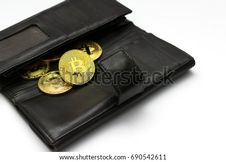 Golden bitcoins on black wallet, Digital symbol of a new virtual currency with white background.