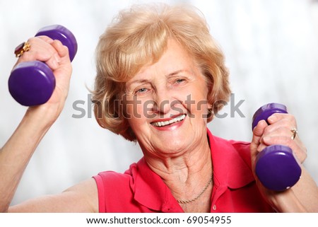 A picture of a senior lady working out with weights over white background