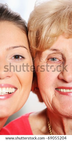 A picture of a grandma and granddaughter smiling over bright background