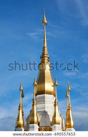 A shrine room topped by a graceful golden chedi and surrounded by eight smaller chedis at Wat Tham Kuha Sawan/Ubon ratchathani/Thailand
