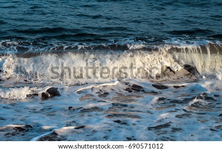 Blue sea water tide closeup photo. Relaxing sea wave surf over seashore. Coastal seaview. Idyllic seascape for summer vacation. Exotic island seaside banner. Sea close-up. Seawater splash on beach