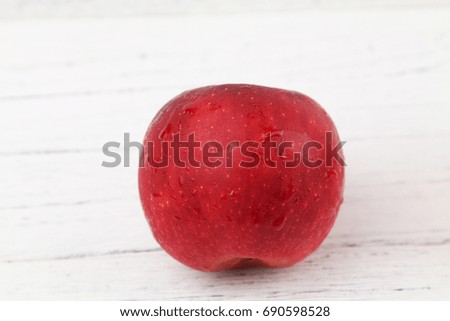 Red apple over wooden texture background