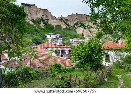 Aerial view with traditional bulgarian houses of Revival period and pyramid mountain rocks in Melnik, Bulgaria
