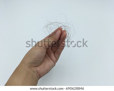Hair Loss in Hand Royalty-Free Stock Photo #690628846