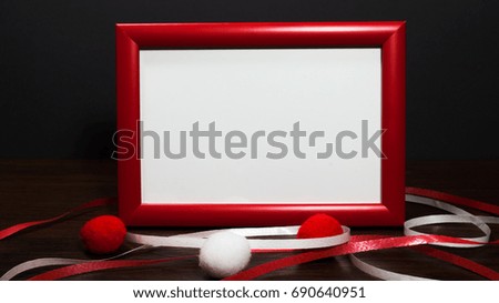 Blank photo frame on the table with. Red color.
