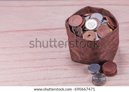 Japanese coins in sackcloth on  wooden  wall background .