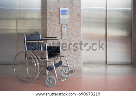 Wheelchair and elevator for disabled, wheelchair waiting in front of elevator in hospital