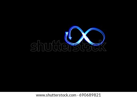  the cold blue infinity sign on a black background at night. Isolated.