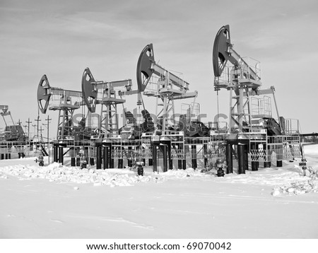Oil pumps in West Siberia. Oil industry equipment. Black and white