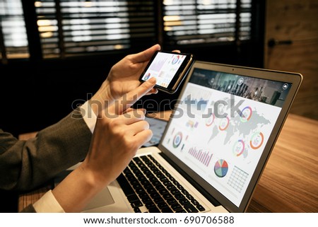 businesswoman using laptop and smart phone.