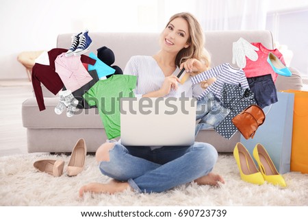 Young woman using laptop for browsing internet store at home. Online shopping concept