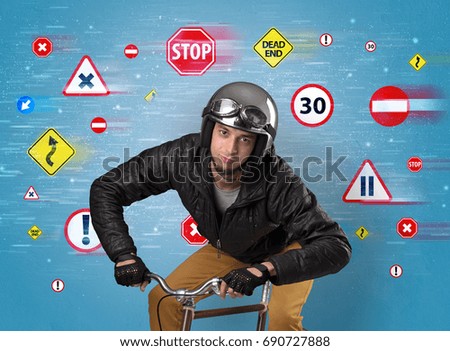 Young guy with stylish outlook and highway code on the background