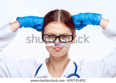 Young beautiful woman on white isolated background holds a syringe, medicine, doctor, emotions.