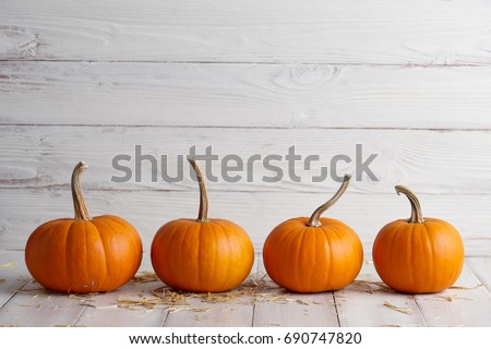 Orange halloween pumpkins on white planks, holiday decoration Royalty-Free Stock Photo #690747820
