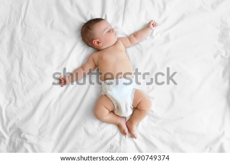 Cute little baby sleeping on bed at home Royalty-Free Stock Photo #690749374