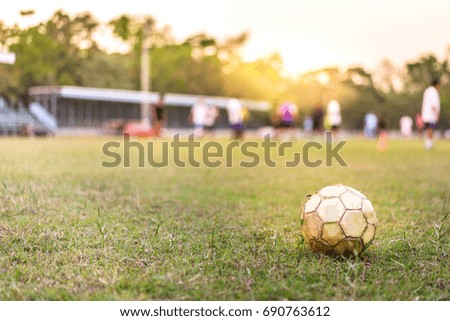 Football on green grass. Soccer football field withe blur people, activity summer concept.