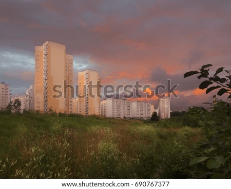 Beautiful bloody sunset over high-rise buildings of the city