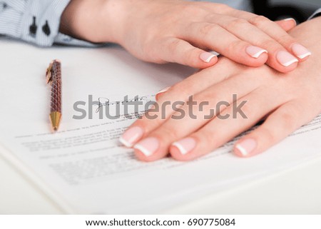 Woman hand signing a contract

