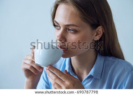 Business woman drinking coffee in the workplace                               