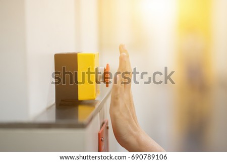 Finger of women pressing emergency sos button to contact with call center to ask for help after car accident ,hand trying to press in front of the elevator,safety first and security background concept