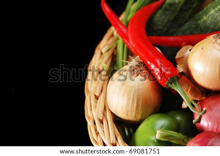 vegetables in the basket on black background
