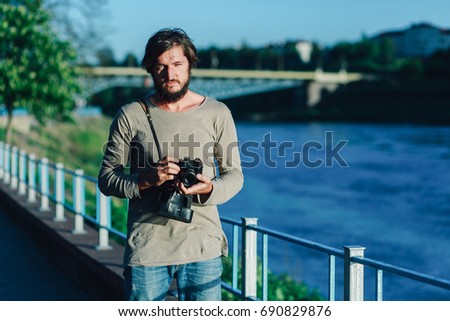 Young Hipster photographer with retro film photo camera