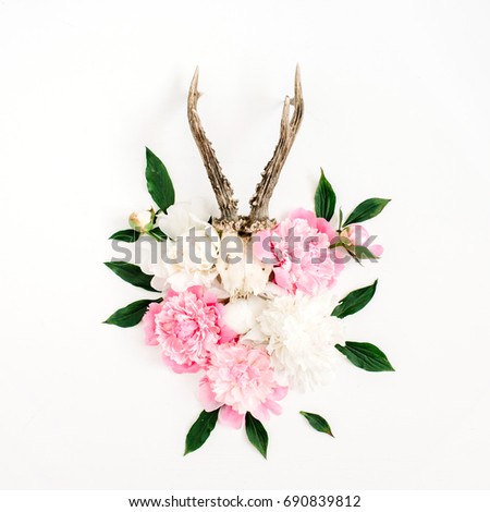 Beautiful pink and white peony flowers bouquet and goat, horns on white background. Flat lay, top view modern stylish hipster background.