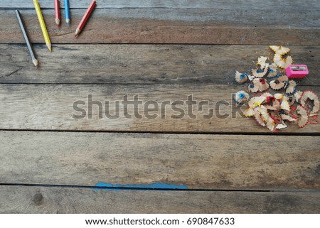 Color pencil trash and sharpener on old wood.