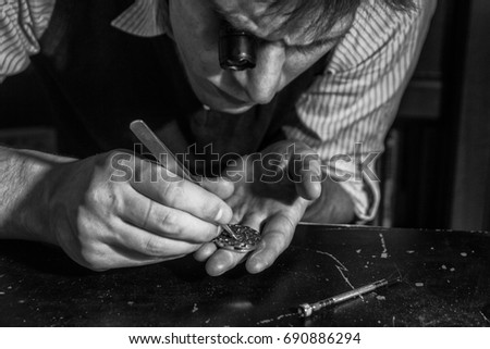 The watchmaker is repairing the mechanical watches in his workshop