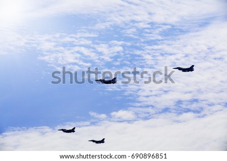 Photo of four jet army planes flying in the blue sky while doing maneuvers