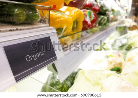 Organic food signage on modern supermarket fresh produce vegetable aisle to appeal to healthy lifestyle shoppers